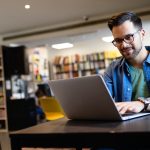 Student preparing exam and learning lessons in school library