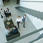 Three little groups of business people discussing working points at break